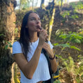 A photo of a girl hiking in Vancouver while eating a churchkhela by chella.